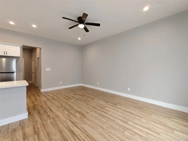 a view of an empty room and wooden floor