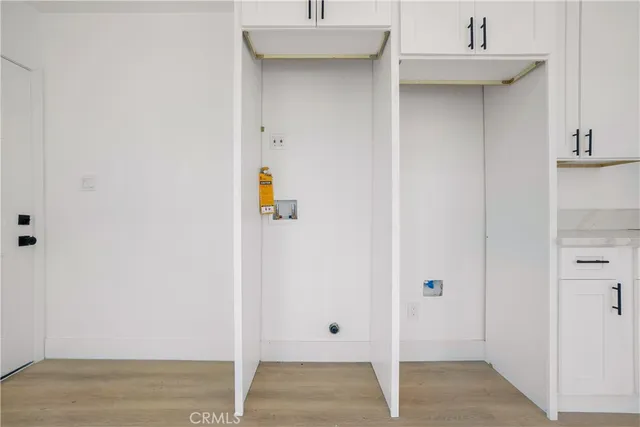 a kitchen with granite countertop a refrigerator and a stove top oven