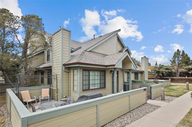 a view of a house with pool and chairs