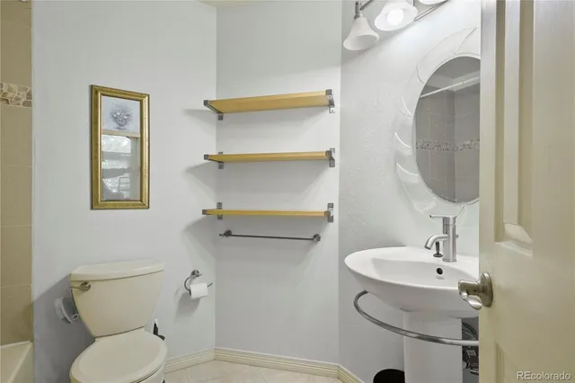 a living room with furniture a fireplace and a window