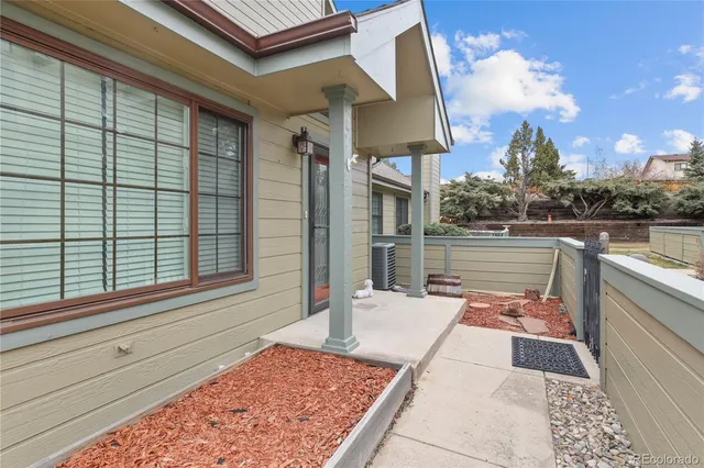 a balcony with furniture and a potted plant