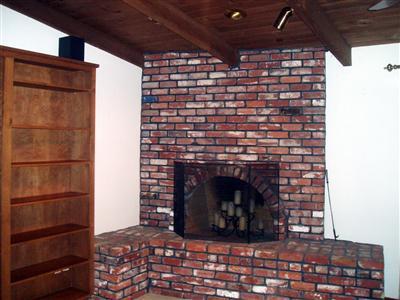 10580 Millerton Road Clovis, CA 93619 - Photo 24 of 45 Bonus Room/Den with Masonary Fireplace builtin bookcases, vaulted ceilings and Sliding glass doors to the back courtyard.