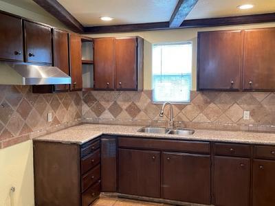 9813 Prunedale South Road Salinas, CA 93907 - Photo 14 of 18 a kitchen with stainless steel appliances granite countertop wooden cabinets and a sink