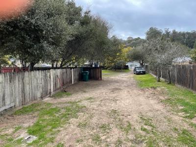 9813 Prunedale South Road Salinas, CA 93907 - Photo 9 of 18 a view of a backyard with large trees and wooden fence