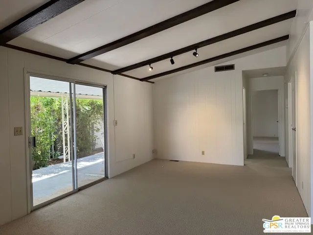 a view of a kitchen with large windows