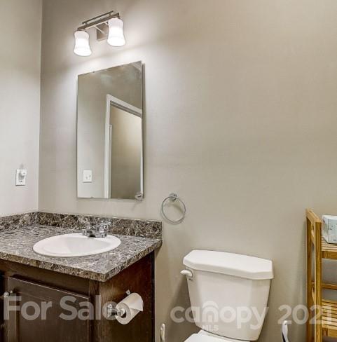 4910 Huntington Farm Road Catawba, SC 29704 - Photo 15 of 20 a bathroom with a granite countertop toilet sink and mirror