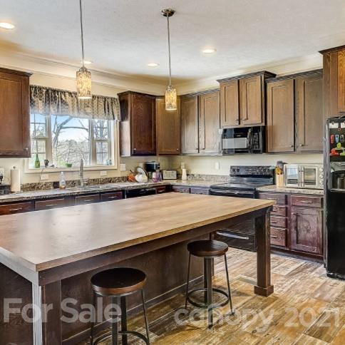 4910 Huntington Farm Road Catawba, SC 29704 - Photo 7 of 20 a kitchen with stainless steel appliances granite countertop a stove a sink and a refrigerator
