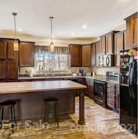 4910 Huntington Farm Road Catawba, SC 29704 - Photo 8 of 20 a kitchen with stainless steel appliances granite countertop a sink stove and refrigerator