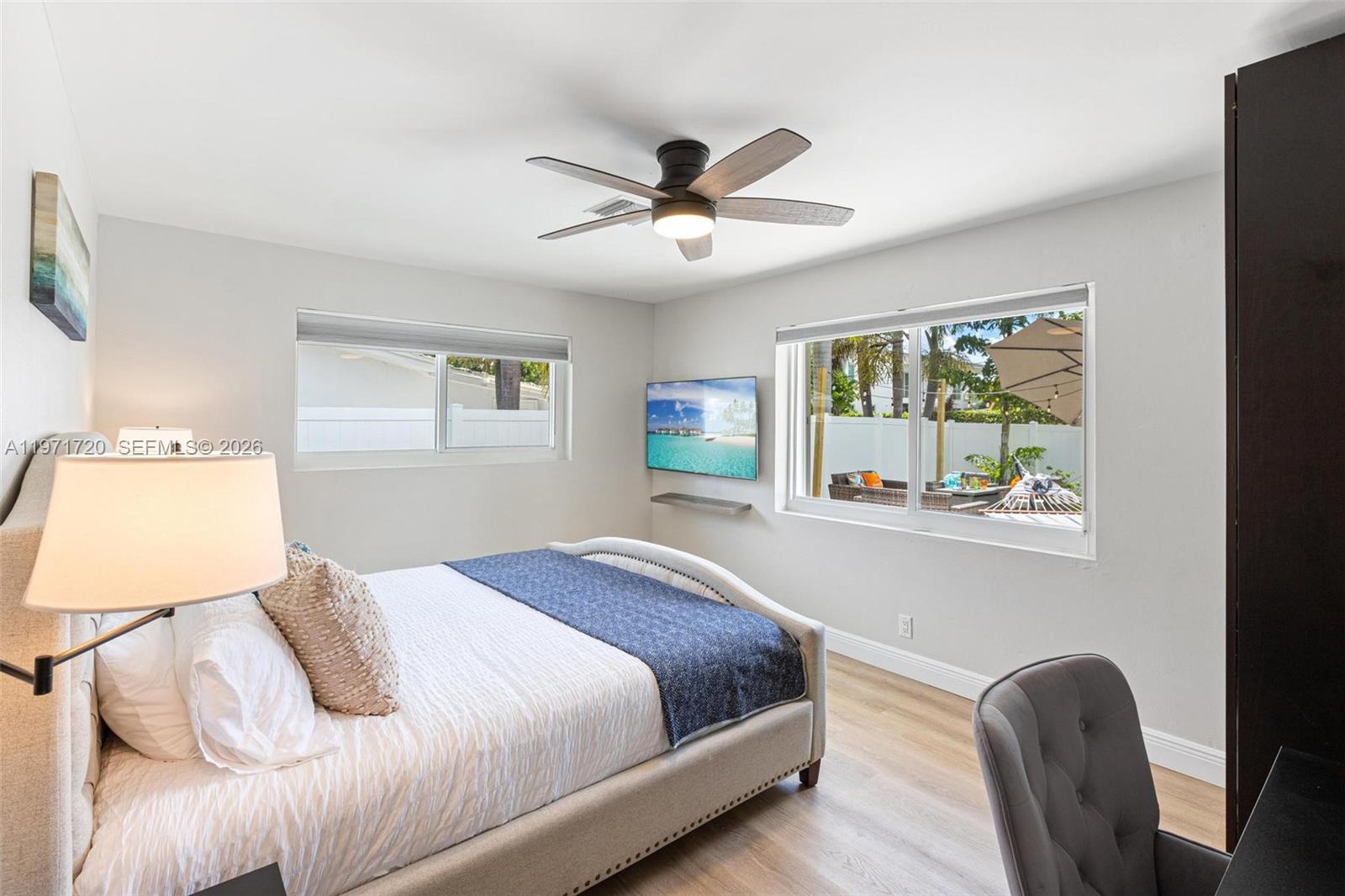 2770 Northeast 30th Street Lighthouse Point, FL 33064 - Photo 11 of 27 a bedroom with a bed and a chandelier