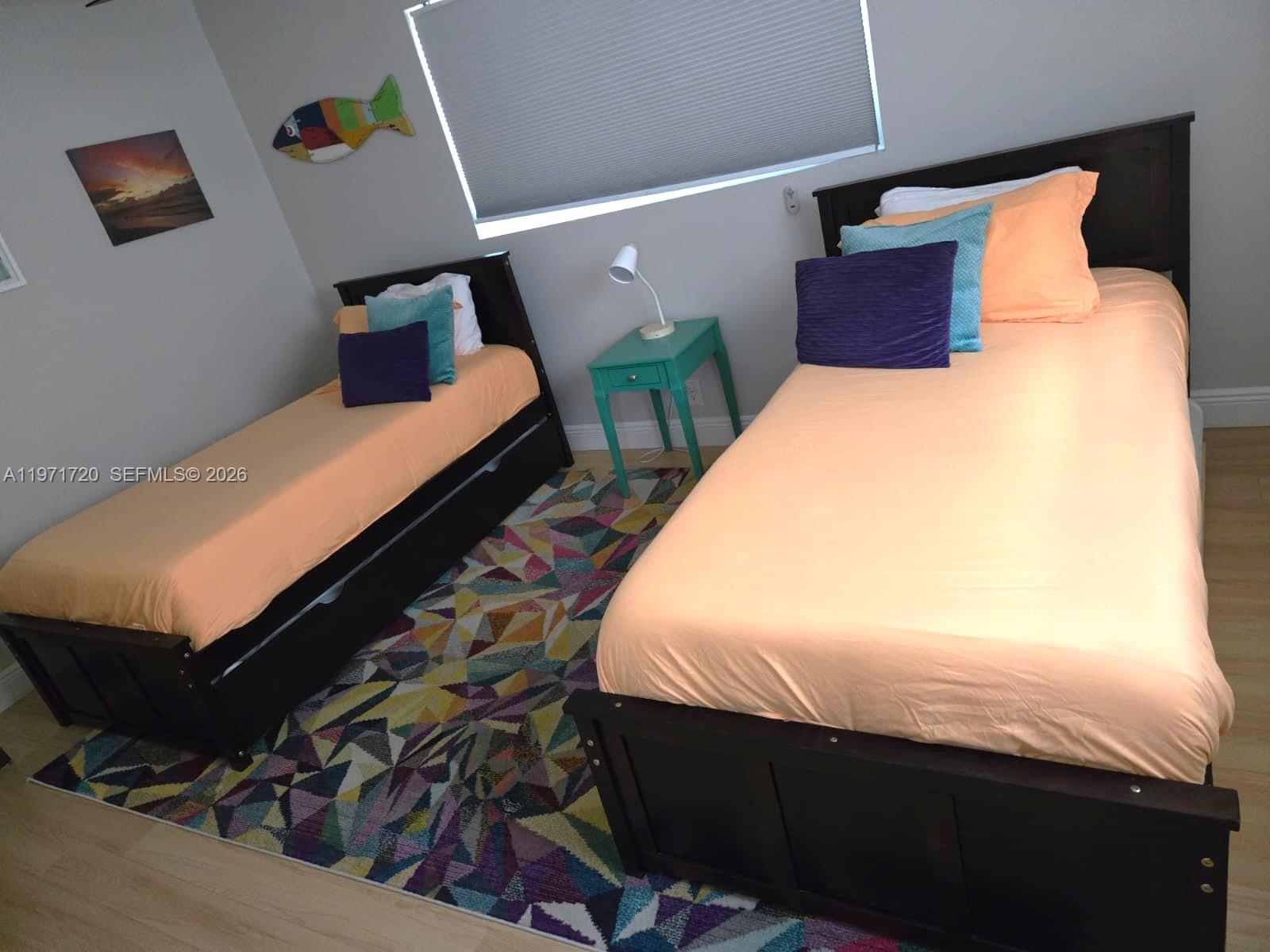 2770 Northeast 30th Street Lighthouse Point, FL 33064 - Photo 16 of 27 a bed sitting in a bedroom next to a lamp