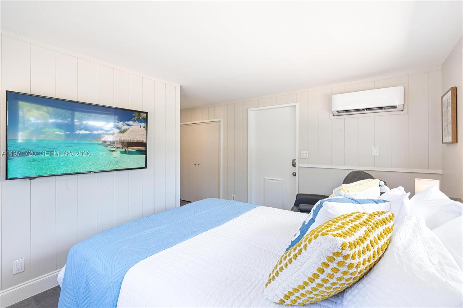 2770 Northeast 30th Street Lighthouse Point, FL 33064 - Photo 19 of 27 a bedroom with a bed and a flat screen tv