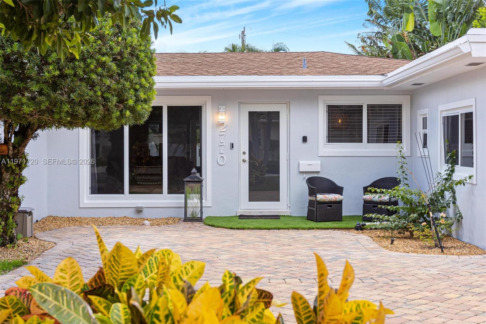 2770 Northeast 30th Street Lighthouse Point, FL 33064 - Photo 2 of 27 a front view of a house with garden