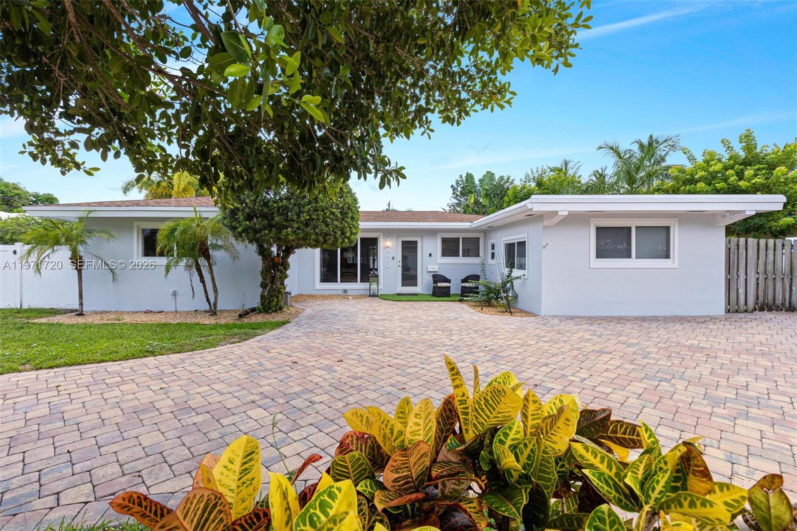 2770 Northeast 30th Street Lighthouse Point, FL 33064 - Photo 4 of 27 a front view of a house with a garden