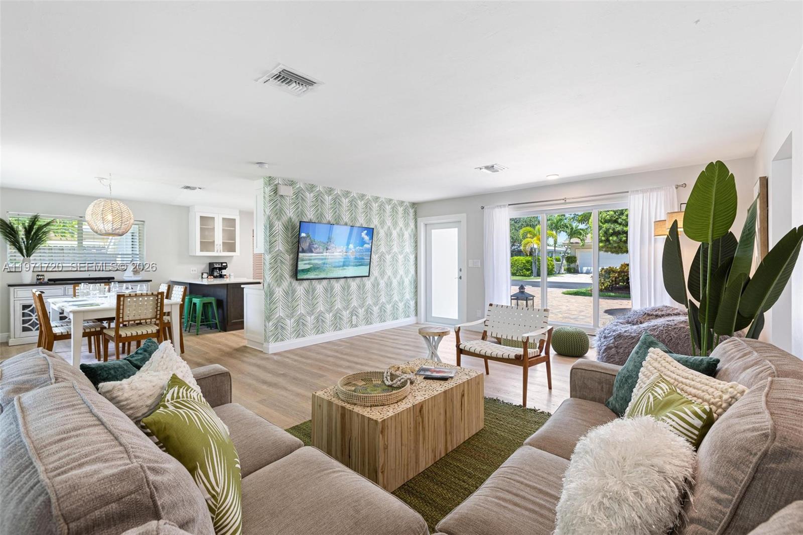 2770 Northeast 30th Street Lighthouse Point, FL 33064 - Photo 6 of 27 a living room with furniture a window and a flat screen tv