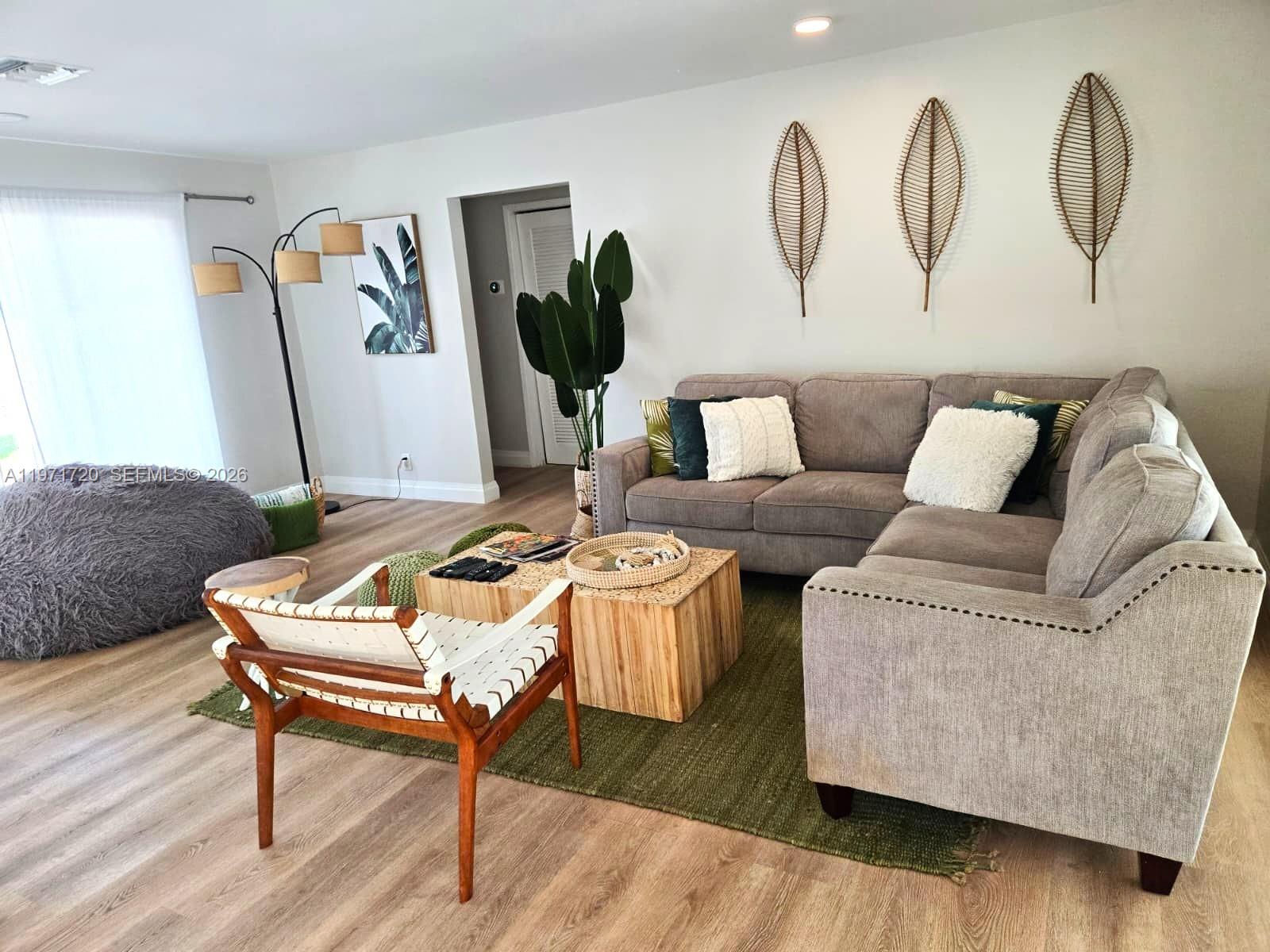 2770 Northeast 30th Street Lighthouse Point, FL 33064 - Photo 7 of 27 a living room with furniture rug and wooden floor