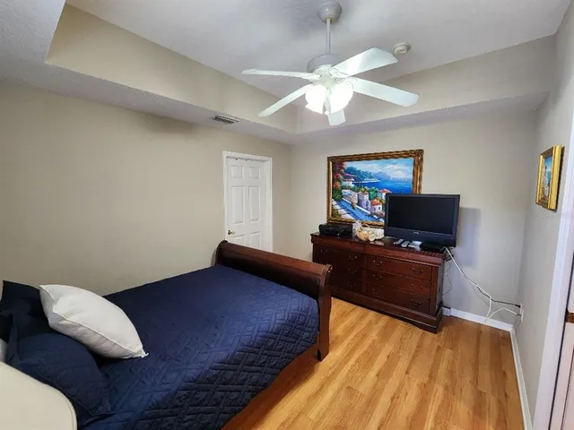 a bedroom with a bed and a chandelier