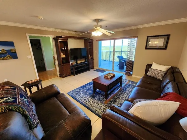 a living room with furniture a rug and a flat screen tv