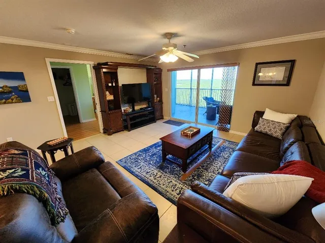 a living room with furniture a rug and a flat screen tv