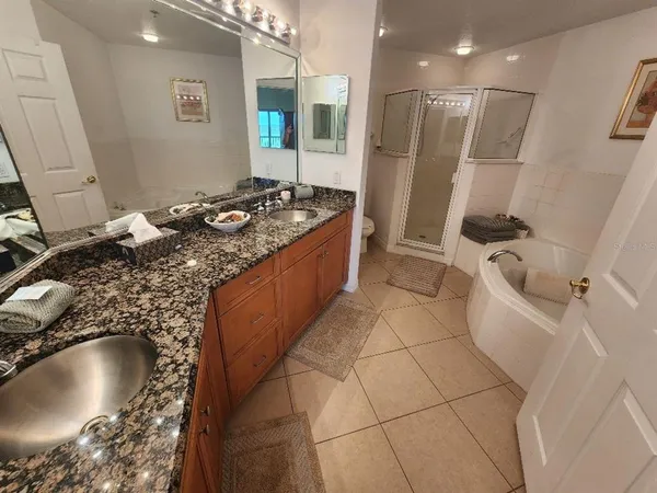a bathroom with a granite countertop sink a toilet and bathtub