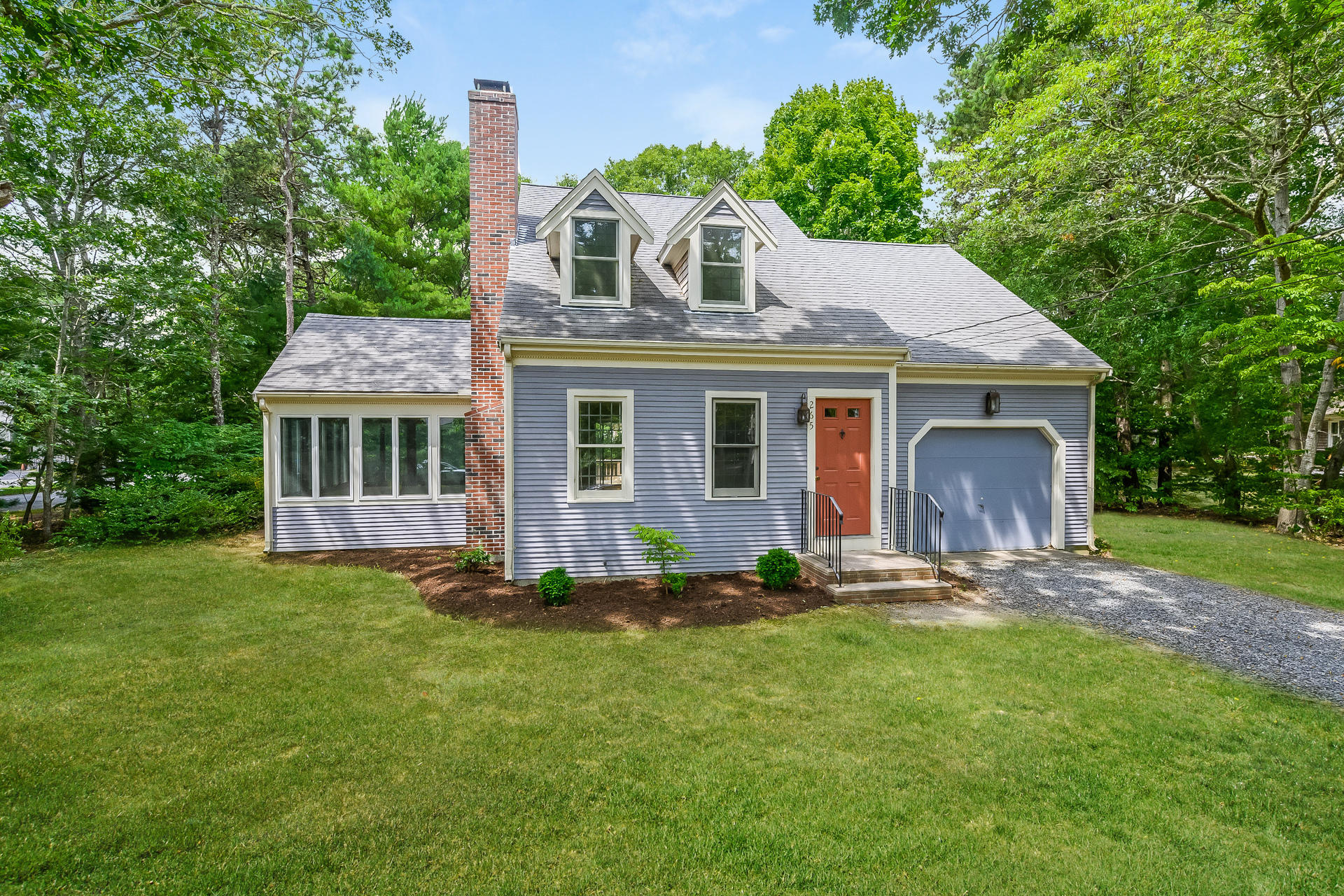 265 Skunknet Road Centerville, MA 02632 - Photo 1 of 20 a front view of a house with a garden