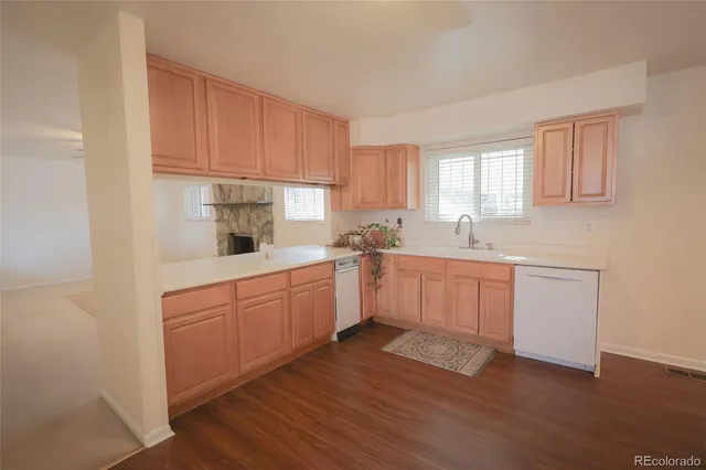 a kitchen with a white cabinets sink and window