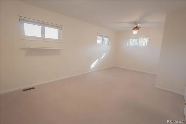 an empty room with windows and closet