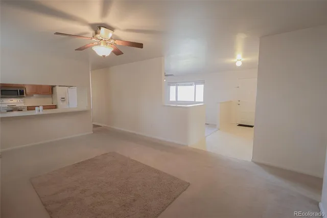 a view of a livingroom with a kitchen