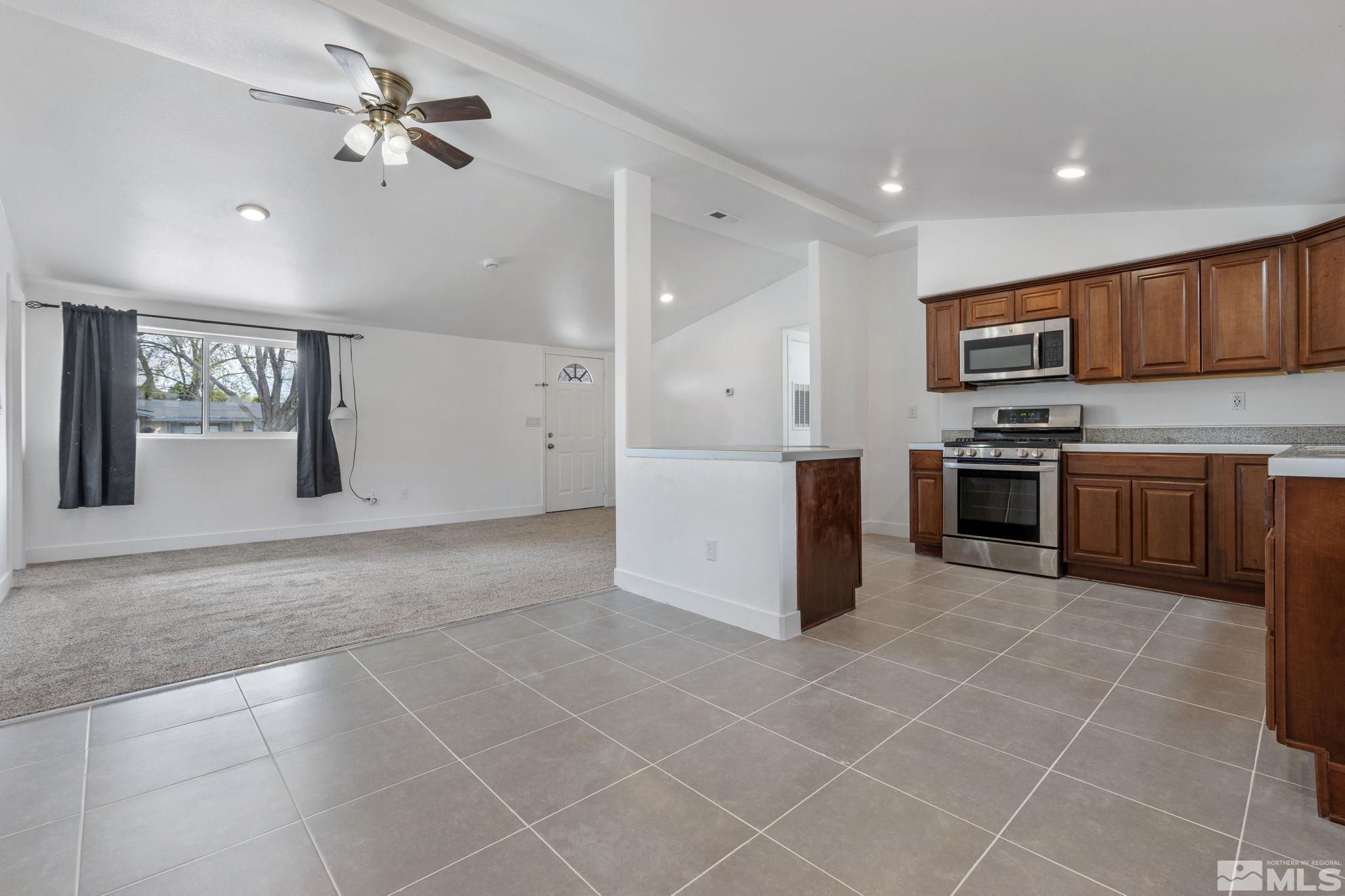 320 M Street Sparks, NV 89431 - Photo 11 of 32 a kitchen with a stove a sink and a refrigerator
