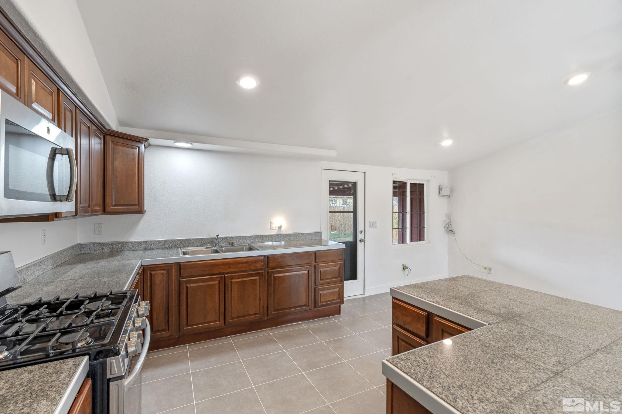 320 M Street Sparks, NV 89431 - Photo 17 of 32 a kitchen with stainless steel appliances granite countertop a stove and a sink