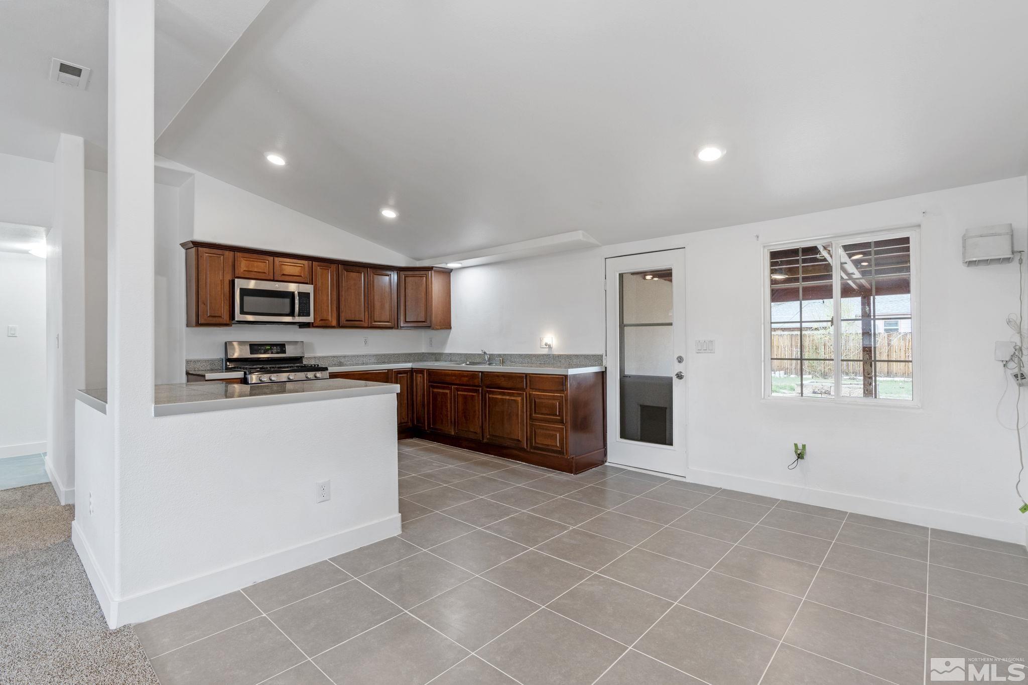 320 M Street Sparks, NV 89431 - Photo 10 of 32 a kitchen with stainless steel appliances granite countertop a stove a sink and a refrigerator