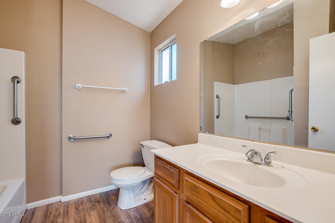 144 North Signal Butte Road Apache Junction, AZ 85120 - Photo 20 of 32 a bathroom with a granite countertop sink a toilet and a mirror