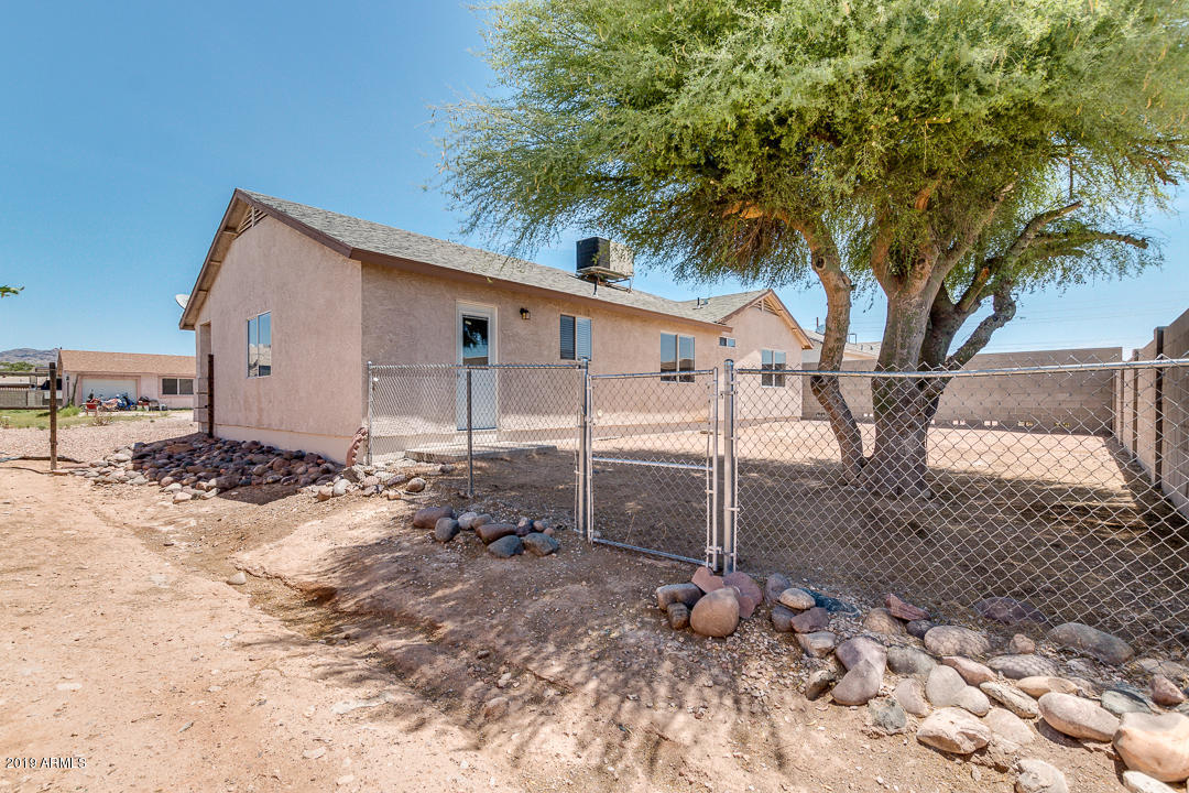 144 North Signal Butte Road Apache Junction, AZ 85120 - Photo 32 of 32 a backyard of a house with table and chairs