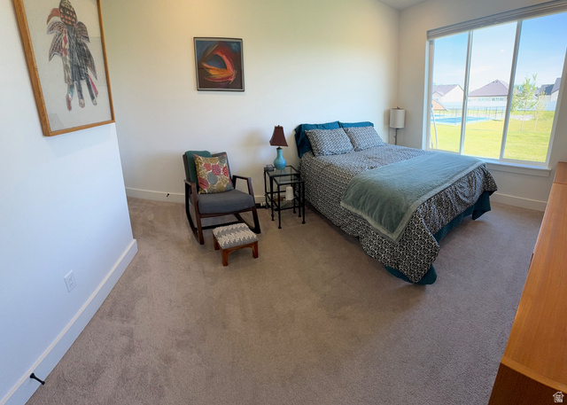 412 West 3025th Street South Logan, UT 84321 - Photo 22 of 34 Carpeted room featuring a large window, white baseboards, and neutral wall tones
