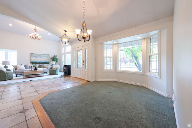875 East 1300th Street North Mapleton, UT 84664 - Photo 10 of 65 Entryway featuring suspended lighting, crown molding, vaulted ceiling, and carpet