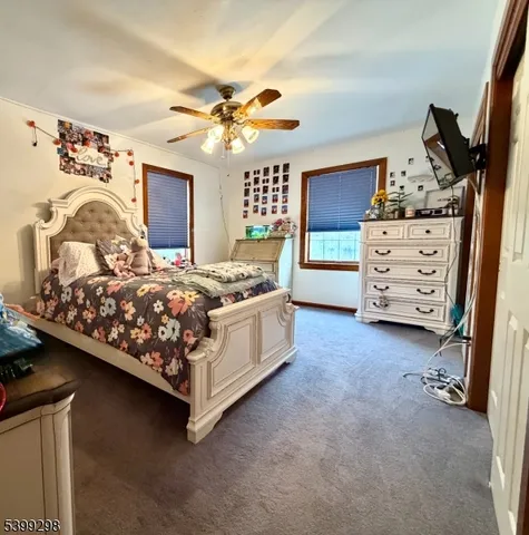 a bed room with a bed and a ceiling fan