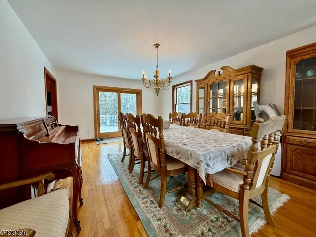 a view of a a dining room with furniture window and wooden floor