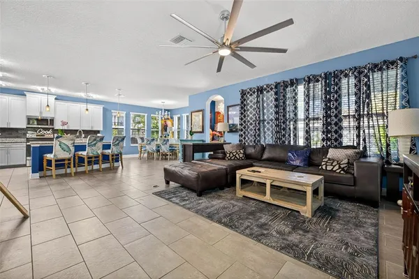 a living room with furniture and kitchen view