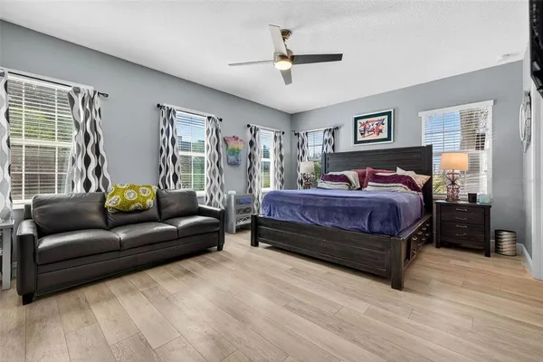 a bedroom with a bed a couch and a window