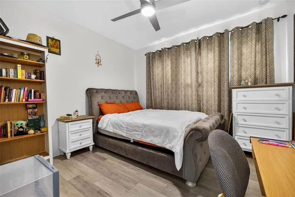 a bedroom with a bed and a book shelf