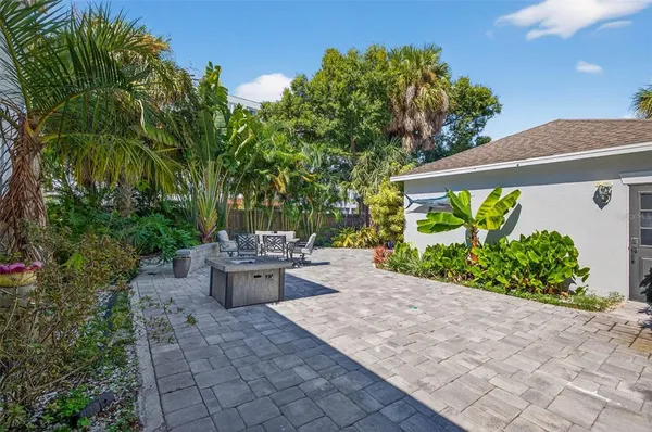 a view of a backyard with garden and plants