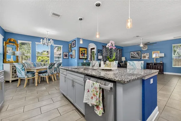 a kitchen with center island table and chairs