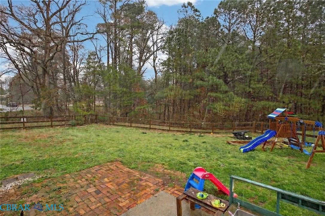 116 Old Field Road Williamsburg, VA 23188 - Photo 27 of 27 Fenced backyard featuring a playground and a patio