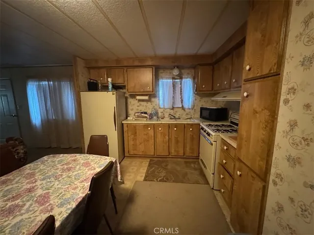 a kitchen with cabinets and refrigerator
