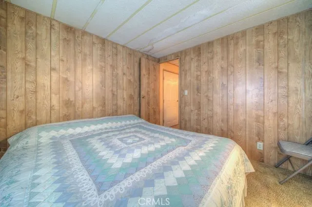 a view of a bedroom with a bed and curtain