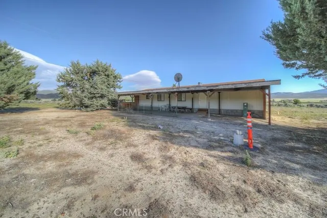 a backyard of a house with table and chairs