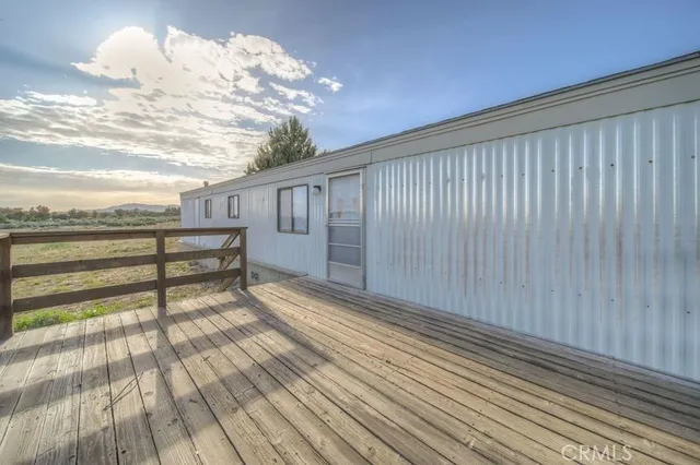 a view of a porch with wooden floor and fence