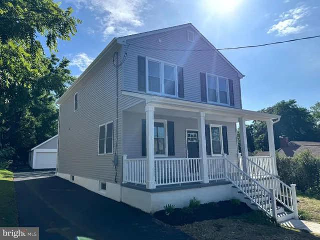 a kitchen with stainless steel appliances granite countertop a sink a stove cabinets counter space and a window