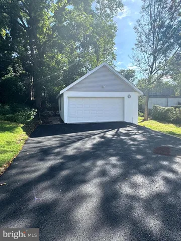 a large kitchen with stainless steel appliances granite countertop a sink and a wooden floor