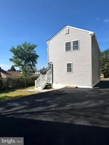 a living room with wooden floor and furniture