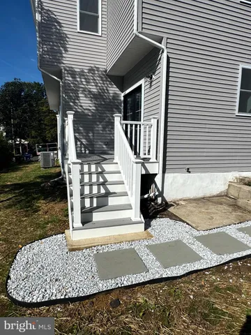 an empty room with wooden floor and entrance